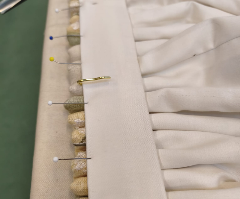 Finishing by sewing on the hooks and turning the facing for a really neat finish.